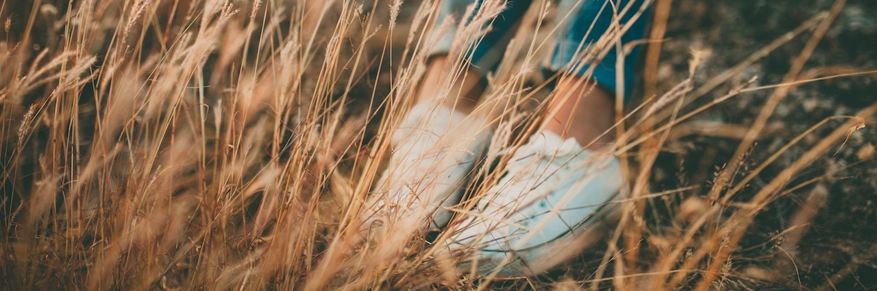 How Observing Nature Might Help Your Anxiety woman sitting in a field of tall grass