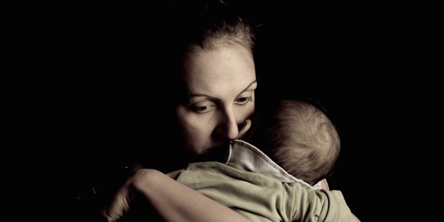 I Want Postpartum Suicide to End – Here Are Some Ways You Can Help mother holding her baby looking sad