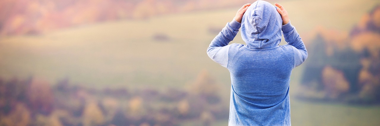What to Remember on Days You 'Fail' in Anxiety and Depression Recovery woman wearing a hoodie looking at mountains