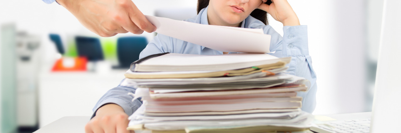 Letter to Legislators Regarding Social Security Disability Woman overwhelmed by papers.