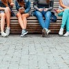 a group of teenagers sitting on steps