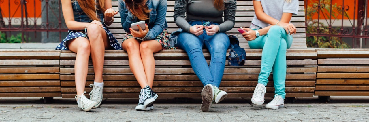 How to Helps a Friend Who Self-Harms and Experienced Trauma a group of teenagers sitting on steps