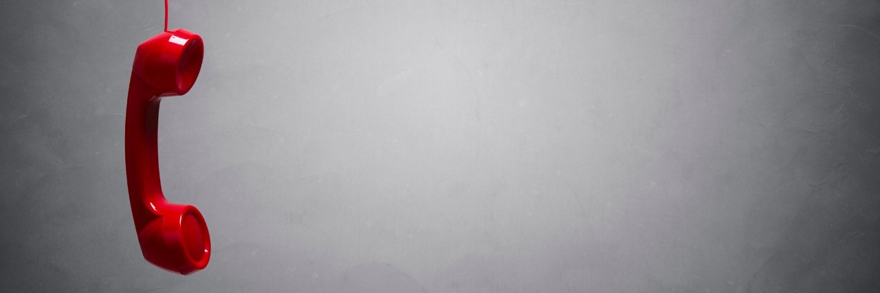 VA's Crisis Line Is Missing and Inadequately Answering Veterans' Calls Red telephone receiver in open space