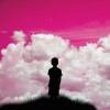 silhouette of boy looking at pink sky
