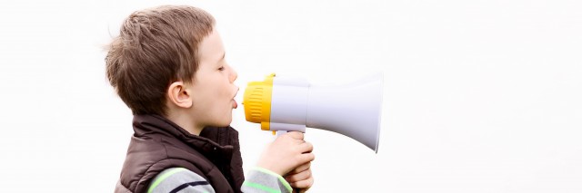 Little boy in the brown vest shouts something into the megaphone - white background
