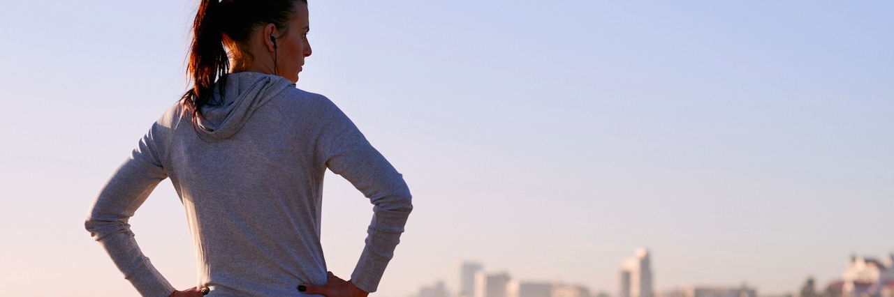 Response to Those Who Ask Why I Bother Trying Even Though I'm Sick woman standing with hands on hips on a beach