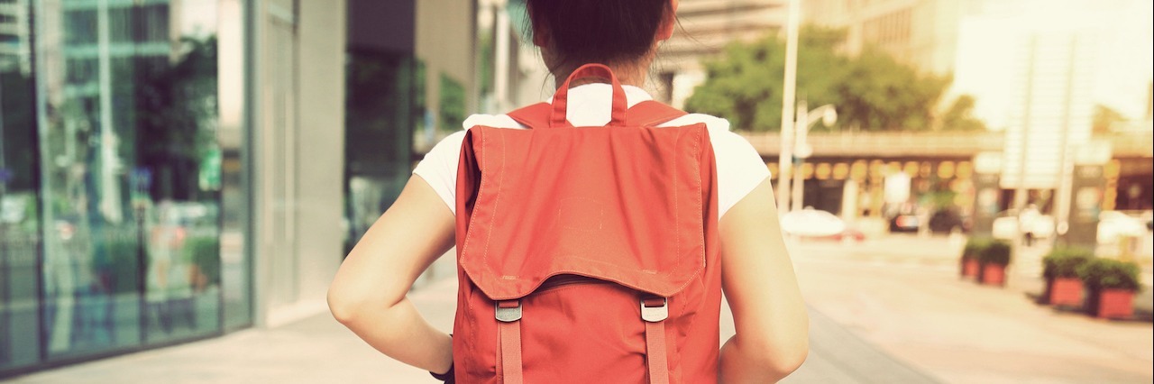 Cerebral Palsy Through a Teenager’s Eyes woman walking down street wearing orange backpack