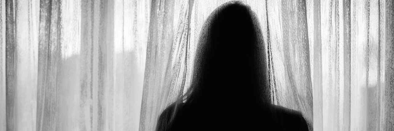 Why Waking Up in the Morning Is Hard With Fibromyalgia silhouette of woman looking through curtain over window