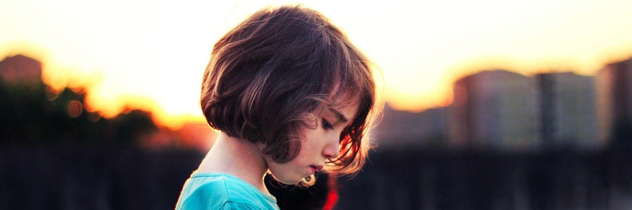 Letter to Sad Girls side profile of sad girl in front of sunset