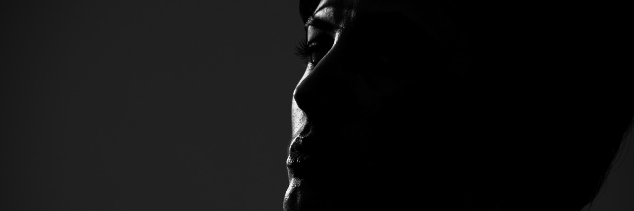 What Made Me Decide to Live After My Suicide Attempt Back lit low key portrait of short hair woman looking at camera
