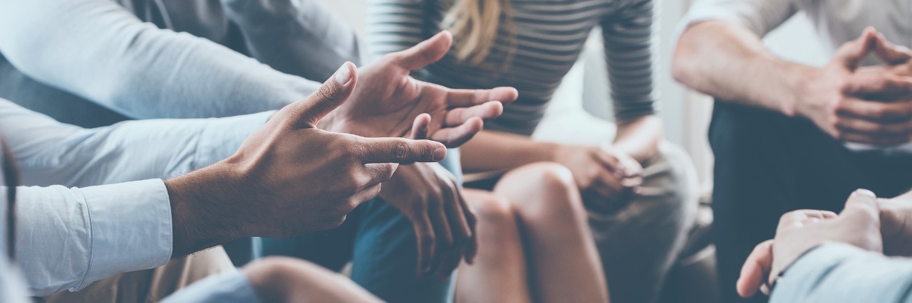 Do Support Groups Help People With Ehlers-Danlos Syndrome? Close-up of people communicating while sitting in circle and gesturing