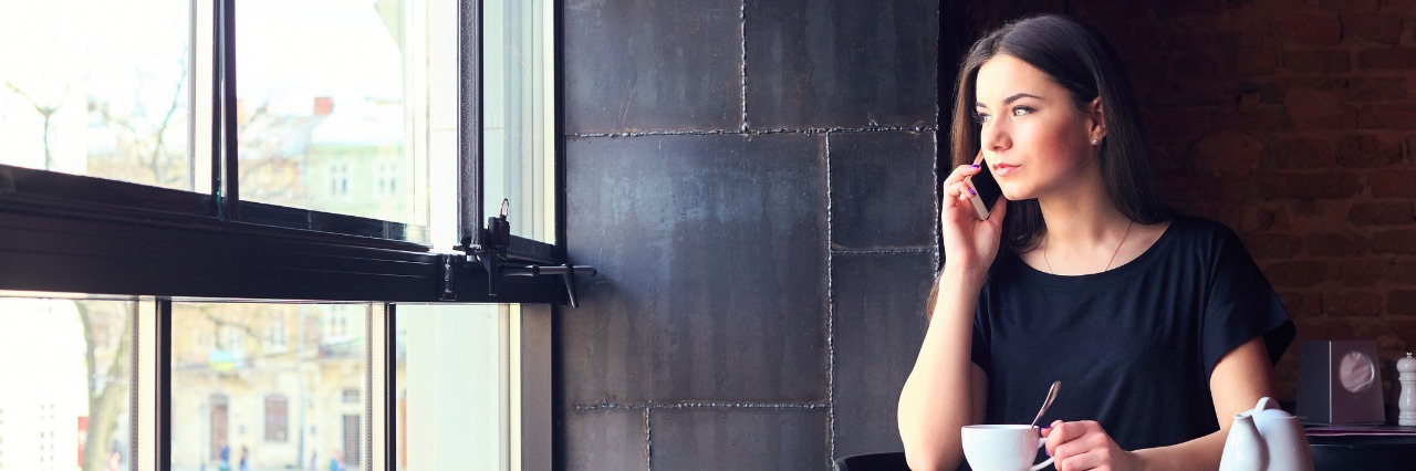 When Anxiety Makes You Stand Up Friends young girl talking on mobile phone while sitting alone in coffee shop