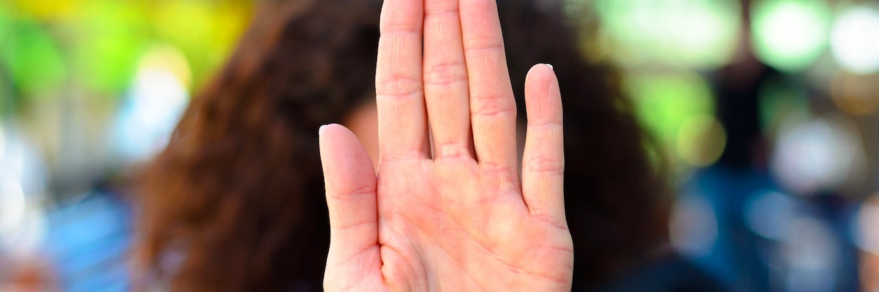 What You Shouldn't Say to Someone With a Mental Illness woman with her hand out