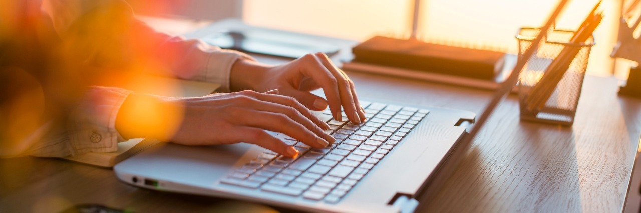Deciding Whether to Share Articles About Your Illness Female teleworker texting using laptop and internet, working online. Freelancer