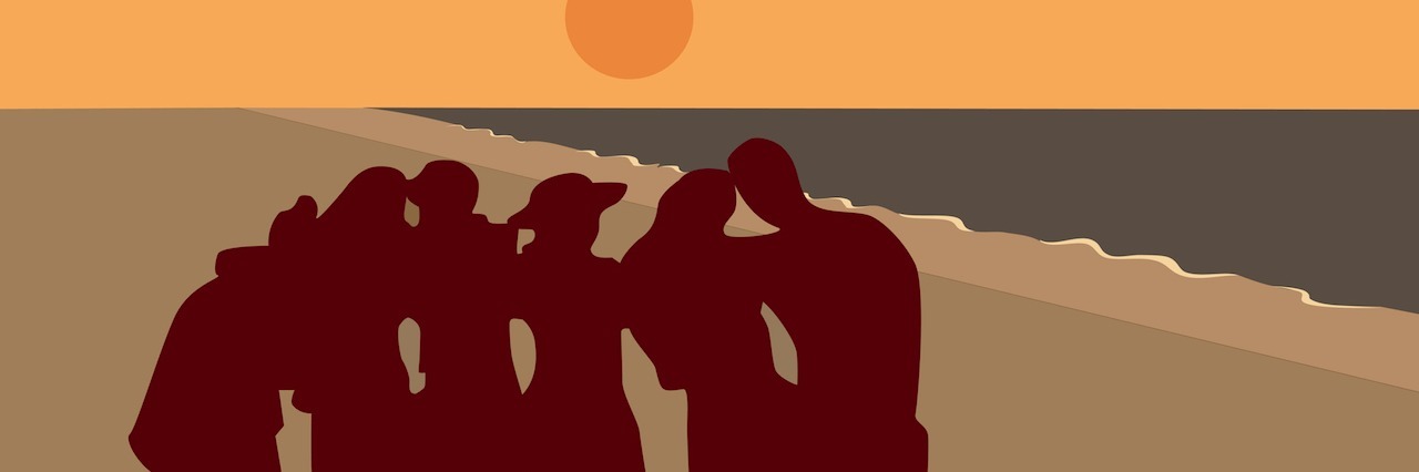 group of people at the beach at sunset