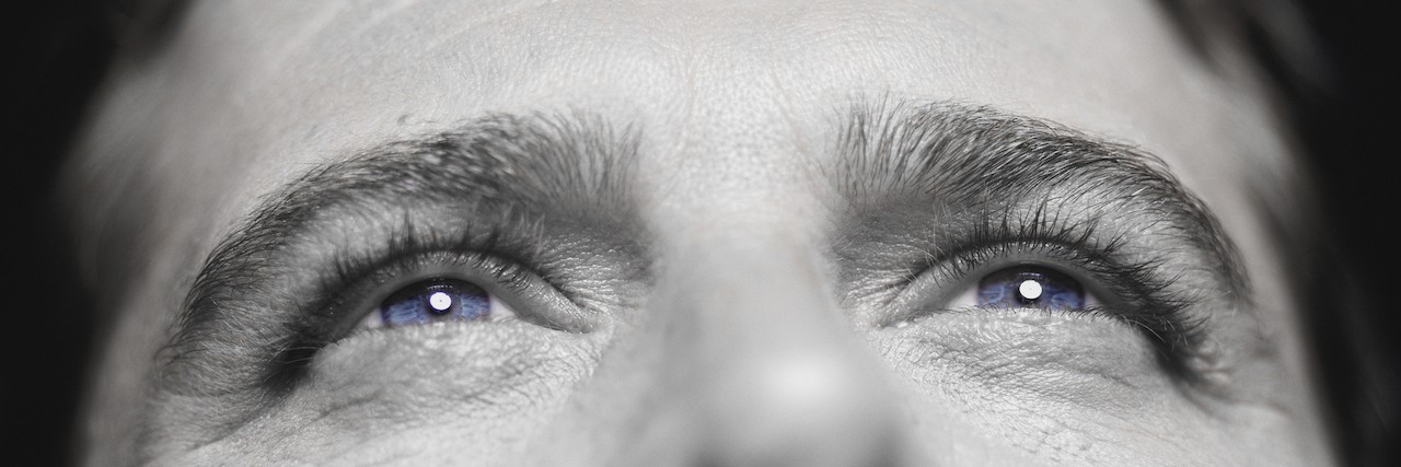 'Suicide Is a Permanent Solution to a Temporary Problem' close up on a man's face looking up