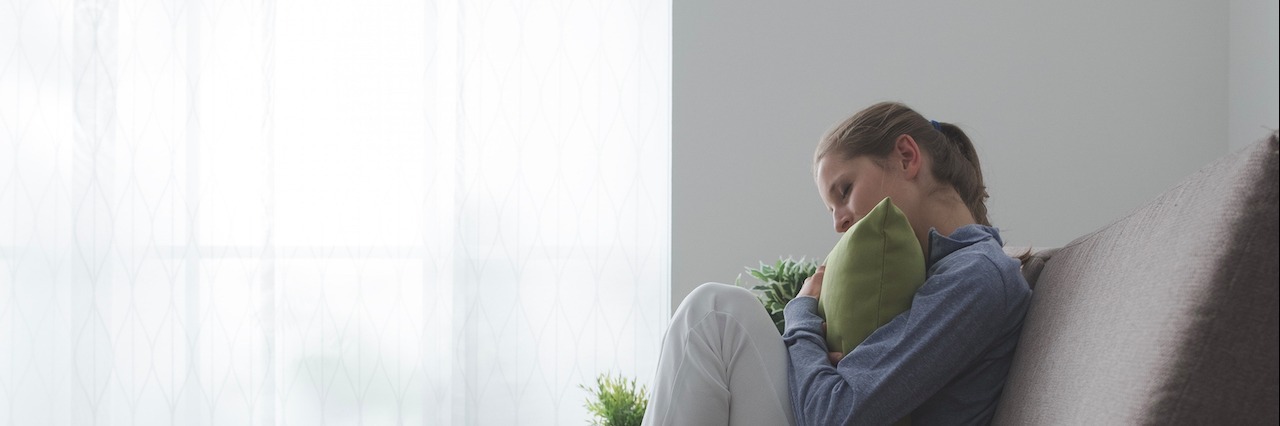 Anxiety That Makes It Hard to Leave the House Sad woman hugging a pillow
