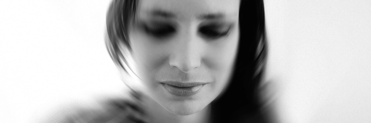 black and white portrait of sad woman in deep thought, thinking, loss, grief, motion blur