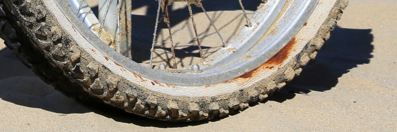 I Refuse to Be a 'Good Disabled' Person Wheelchair in the sand.