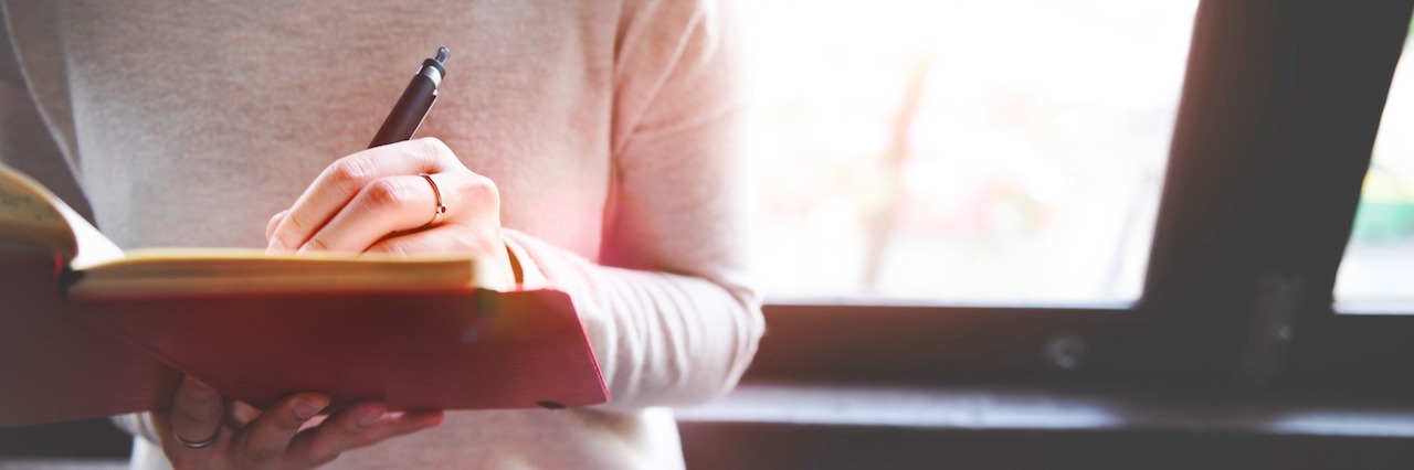 How 'Depression Days' Affect Your Motivation woman writing in a notebook