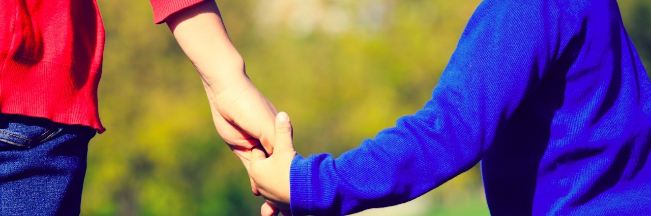 Autism: When My Son's Special Interest Affects His Mental Health Mom holding hand of son as he turns toward her