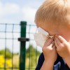 Emotions and feeling. Sad little boy crying, unhappy child wiping his eyes with tissue outdoor