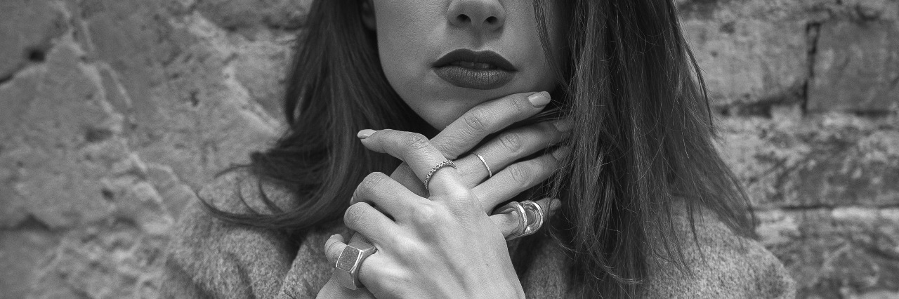 Depression: Why I Don't Let People In young girl posing on brick wall background