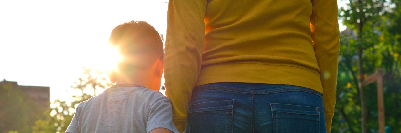 Autism: Questioning If I Did the Right Thing During My Son's Meltdown Child holding hands with parent outdoors during sunset