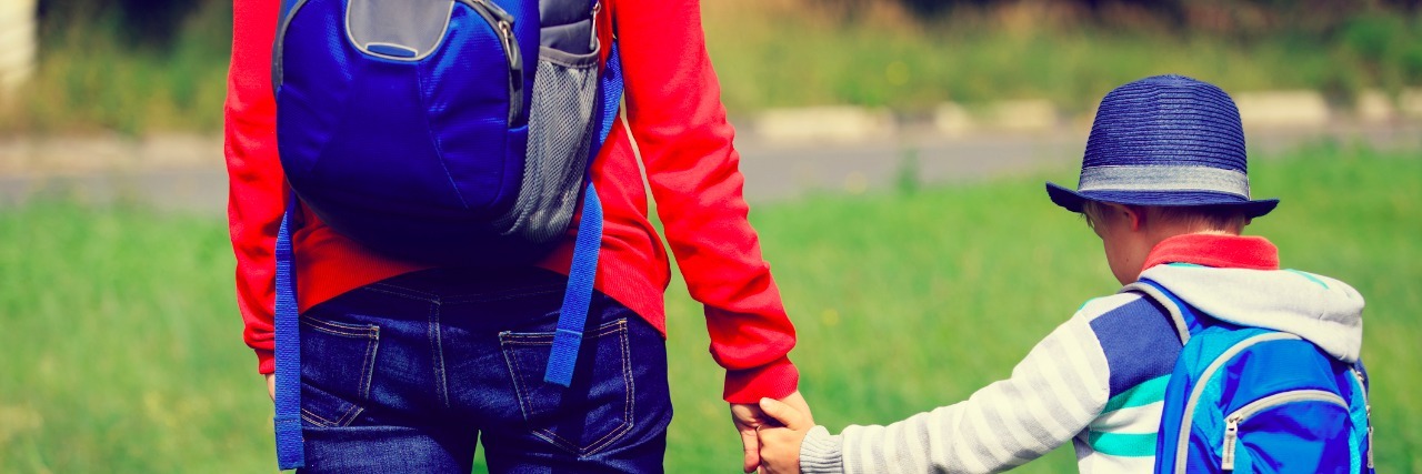Special Needs Parenting: Why We Turn Down Your Invitations back to school- mother holding hand of little son with backpack outdoors