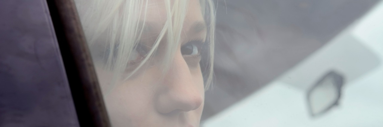 Bipolar Disorder: Discussing Psychosis Without Shame sad woman looking out car window