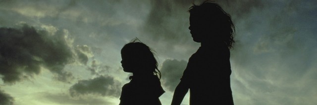 Silhouette of two girls holding hands