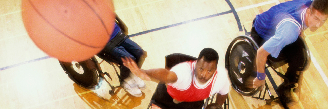 Athletes playing wheelchair basketball.