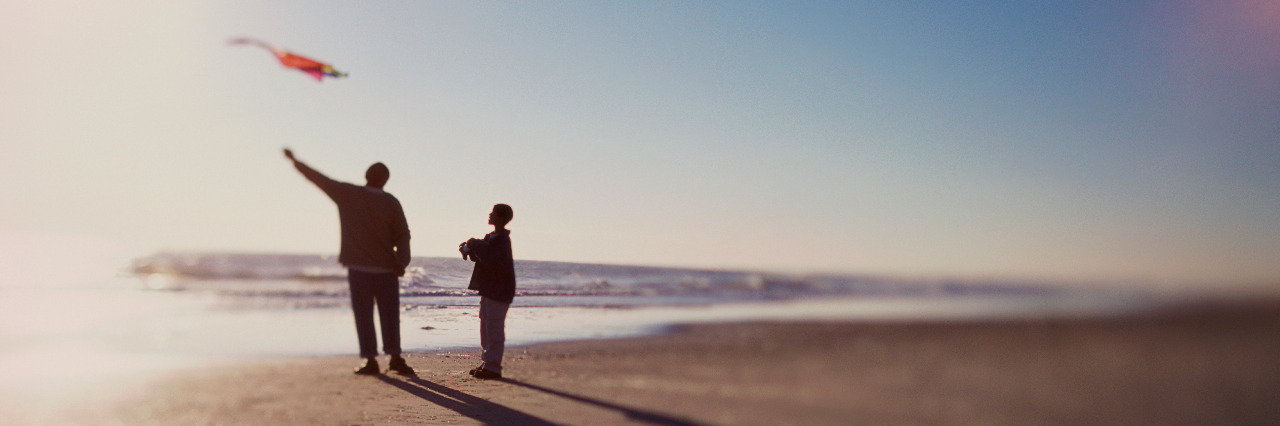 Life After Losing My Father as a Teenager Silhouette of a father and son flying a kite on the beach.