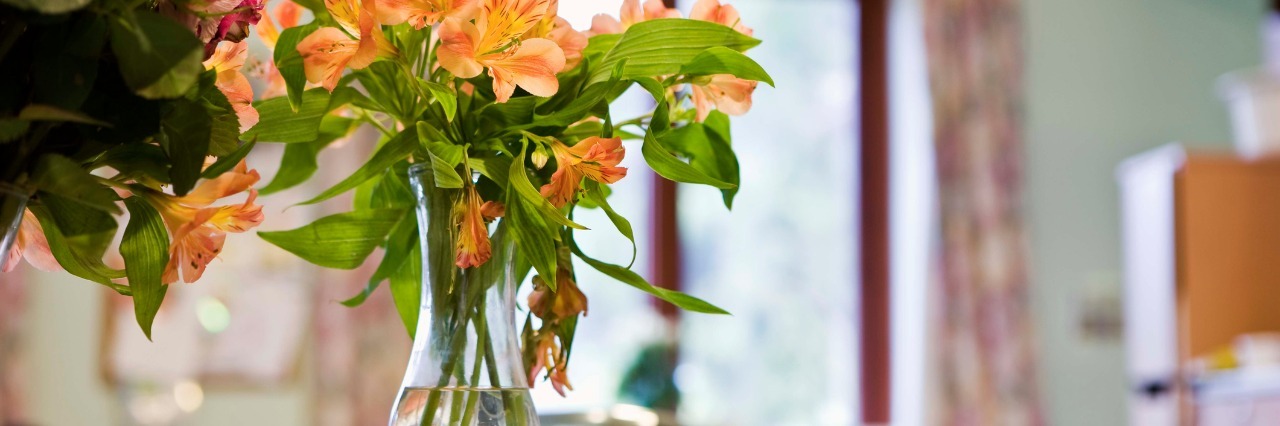 Tips for Preparing for a Hospital Stay bright orange and pink flowers in a vase in a hospital room