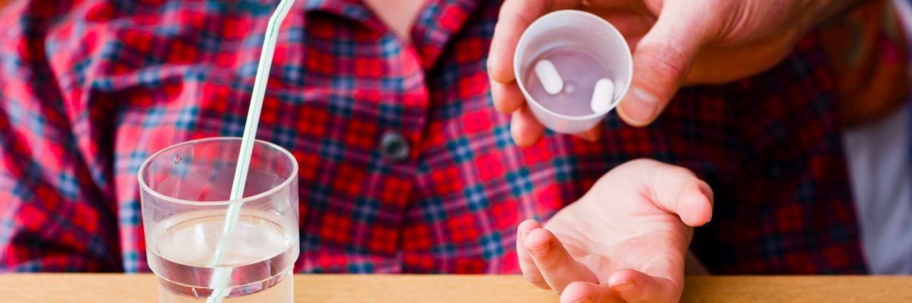 Taking Medication for Mental Illness Is Not a Weakness nurse giving pills to a patient