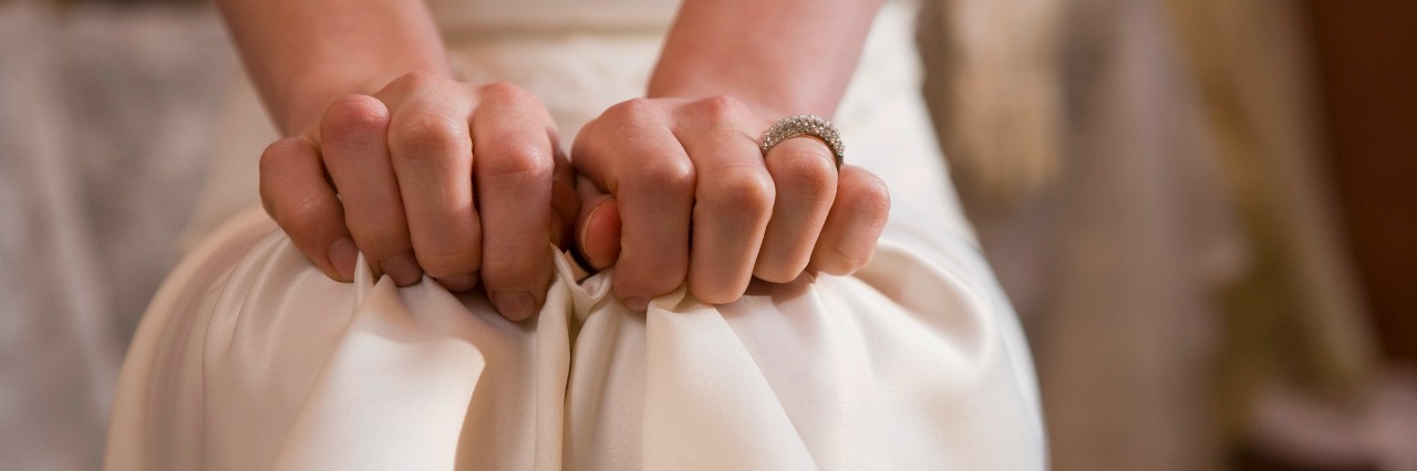 When People Laugh at My Anxiety close up of a womans hands clutching at her dress