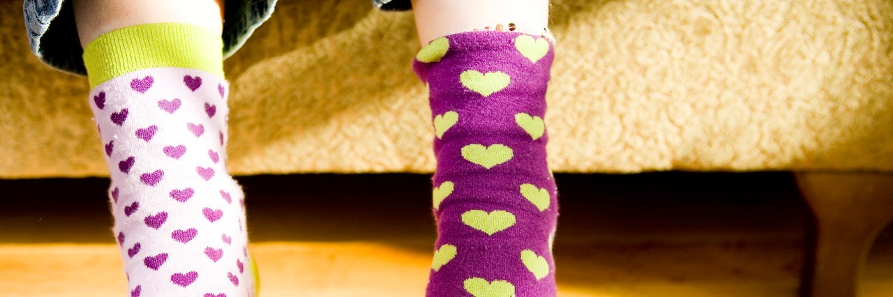 a childs feet clad in novelty socks