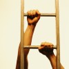 close-up of hands climbing a ladder