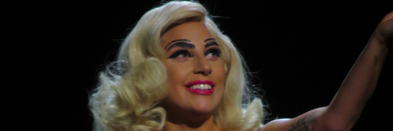 Lady Gaga Song 'Bad Kids' Helps Teen Through Suicidal Episode lady gaga on stage holding a mic in a pink dress