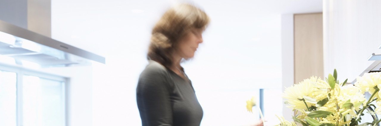 Woman With Lyme Disease Doesn’t Feel Guilty About Her Pain woman in a kitchen