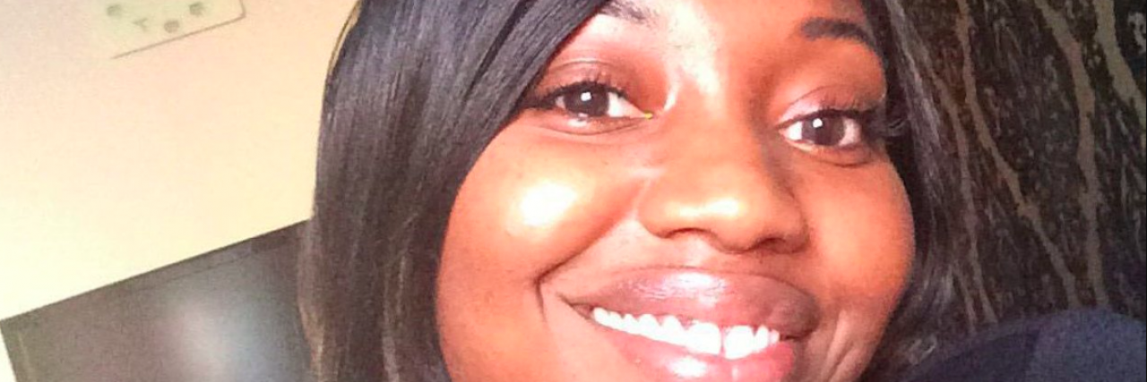 I Took a Moment to Embrace My New Normal and Not Fear Cancer Selfie of contributor, a Black woman, smiling at home