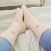 legs and feet wearing socks in hospital bed