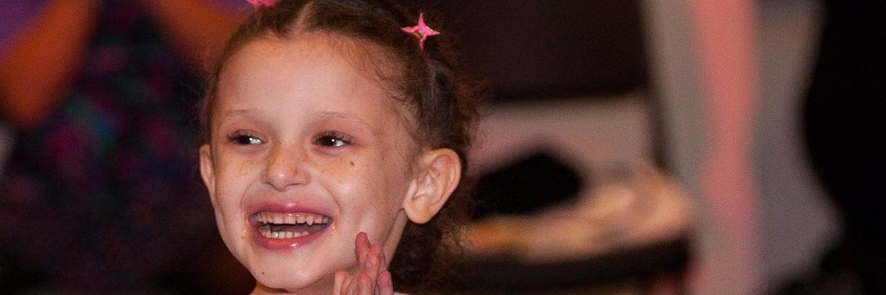 Receiving a B-Cell Lymphoma Diagnosis for Your Child Deja, in a dress, smiling