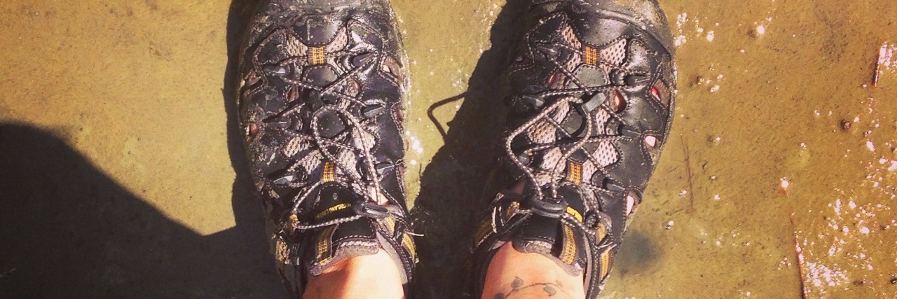 Wondering Who You Are After a Chronic Disease Diagnosis feet wearing hiking shoes standing on wet ground