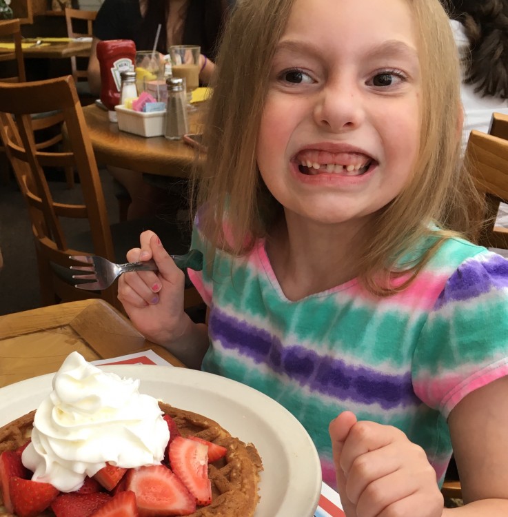 girl eating a gluten-free waffle