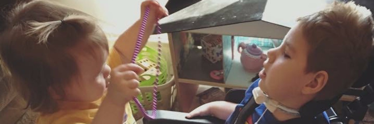 What Our Mornings Are Like for Our Son With Complex Medical Needs sister playing with brother