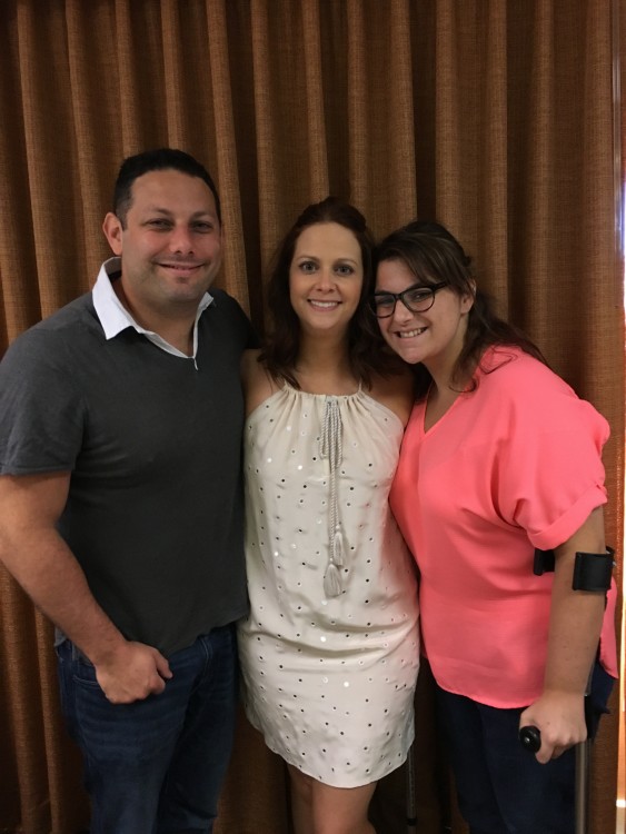 two women and man standing together