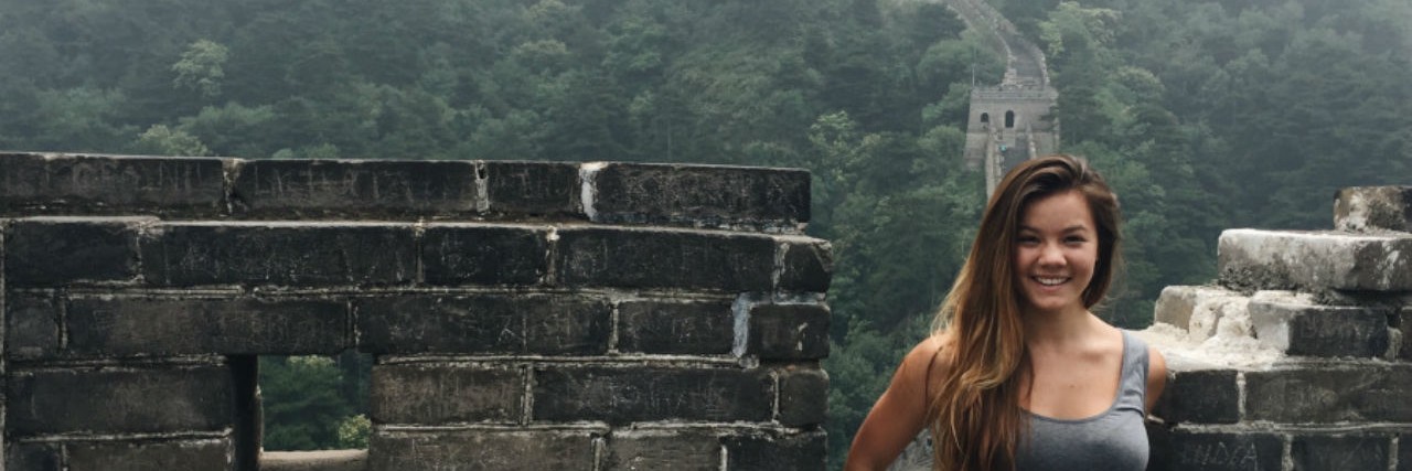 Advocating for Fitness After Combating an Eating Disorder young woman posing at the Great Wall of China