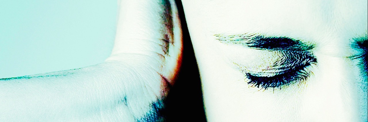 Fighting Chronic Pain From Lyme Disease With Pain woman putting hand on her head with eyes closed