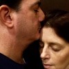 husband kissing wife on forehead